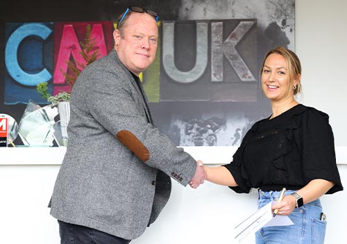 Sarah Neate, Marketing Director, CMYUK with Chris Davies, Event Director, The Print Show signing contract for The Print Show 2024