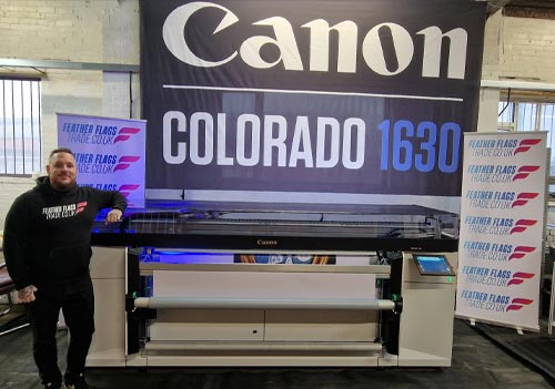 Josh Candy from featherflagstrade.co.uk with a Canon Colorado 1630 UV LED printer from CMYUK.