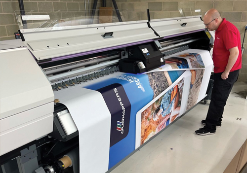 Andy Thomas from Impressions with a Mimaki UJV55-320 UV LED 3.2m roll printer from CMYUK 