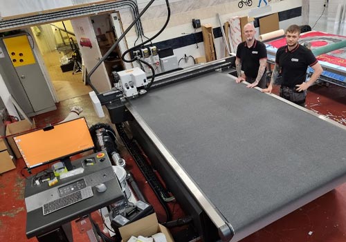 Steve Goodfellow and son with a Kongsberg X24 digital cutting table from CMYUK.
